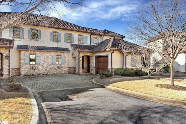 mediterranean / spanish house featuring a garage