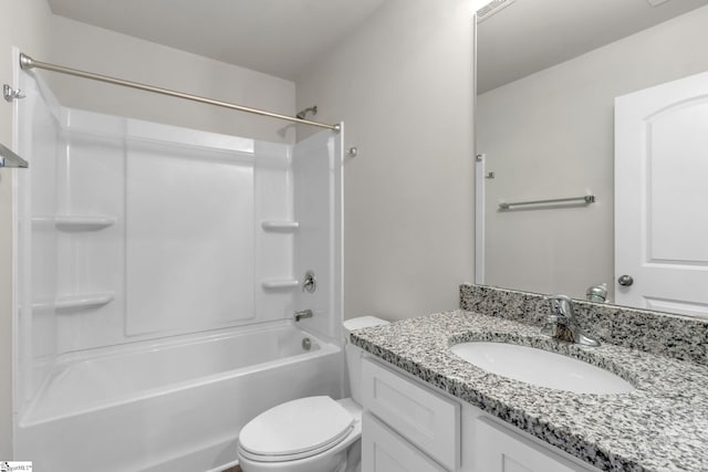 full bathroom featuring washtub / shower combination, vanity, and toilet