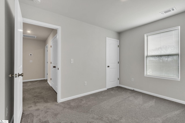 spare room featuring light carpet and a healthy amount of sunlight