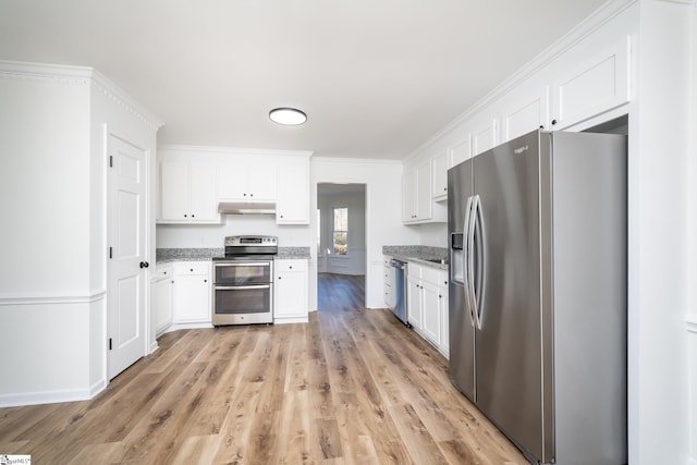 kitchen with white cabinets, light stone countertops, stainless steel appliances, and ornamental molding