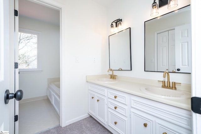 bathroom featuring a washtub and vanity