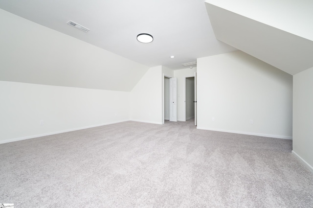 bonus room featuring light carpet and vaulted ceiling