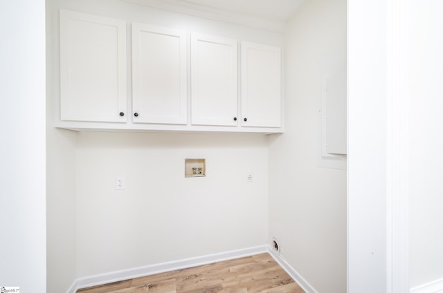 washroom with electric dryer hookup, cabinets, hookup for a washing machine, and light hardwood / wood-style flooring