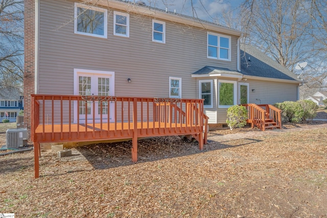 back of property featuring a wooden deck and central AC