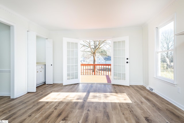 interior space with french doors, hardwood / wood-style floors, and plenty of natural light