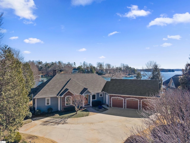 view of front of house with a garage and a water view