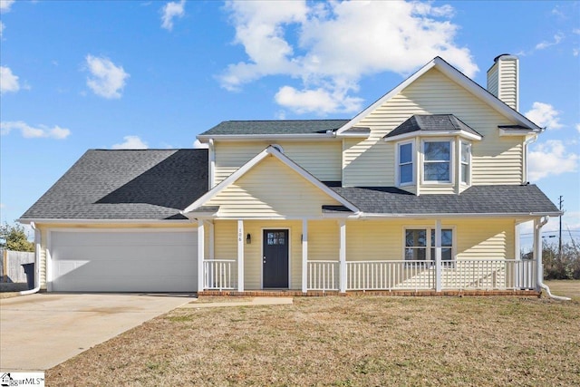 view of front of home featuring a porch, a garage, and a front lawn