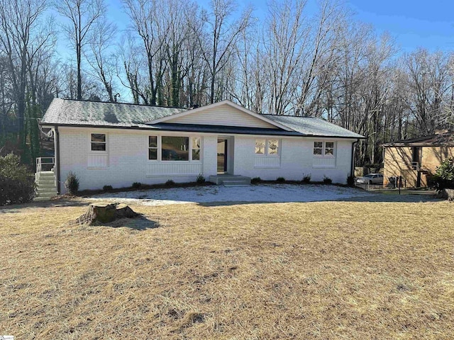 ranch-style home with a front lawn