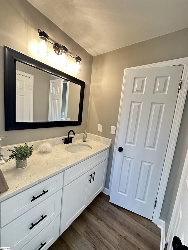 bathroom featuring vanity and wood finished floors