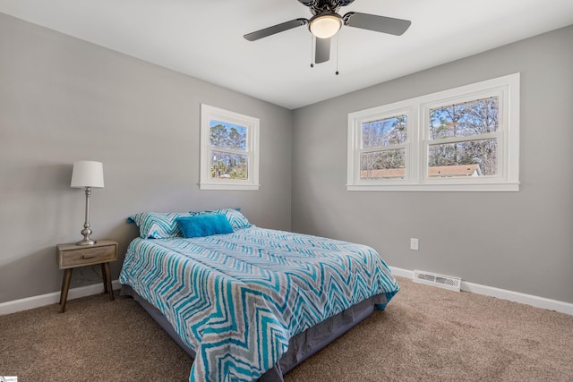 carpeted bedroom featuring multiple windows, visible vents, and baseboards