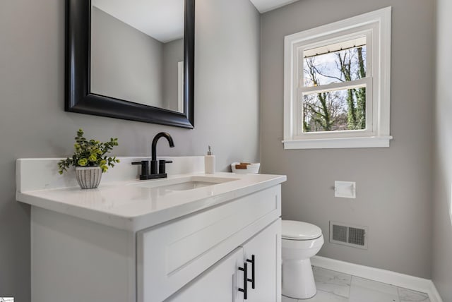 bathroom featuring baseboards, visible vents, toilet, marble finish floor, and vanity