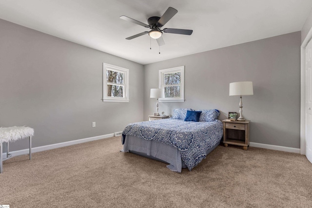 carpeted bedroom featuring ceiling fan and baseboards