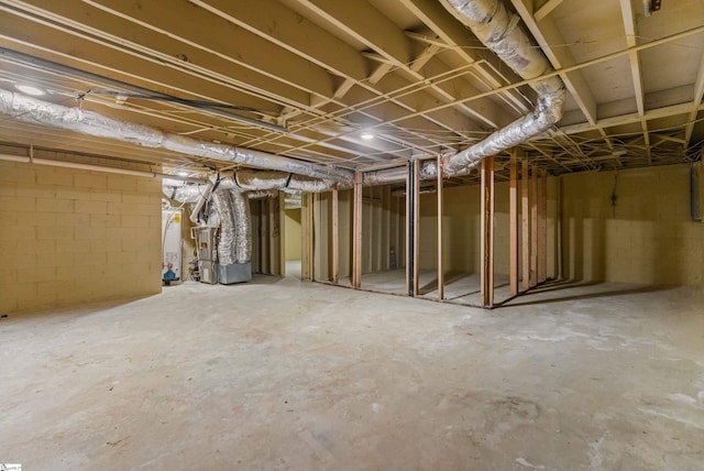 unfinished basement featuring gas water heater