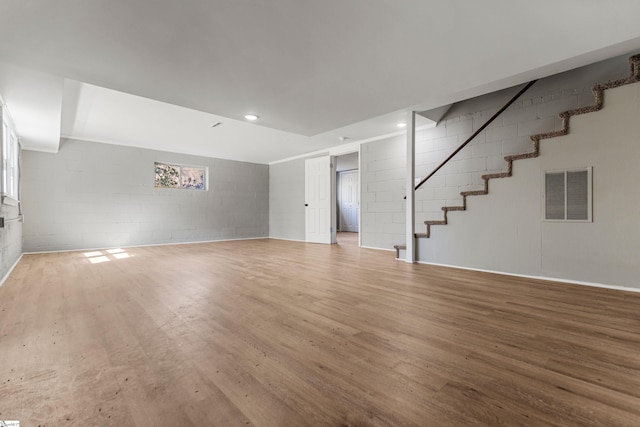 unfurnished living room featuring recessed lighting, visible vents, a healthy amount of sunlight, light wood-style floors, and stairway