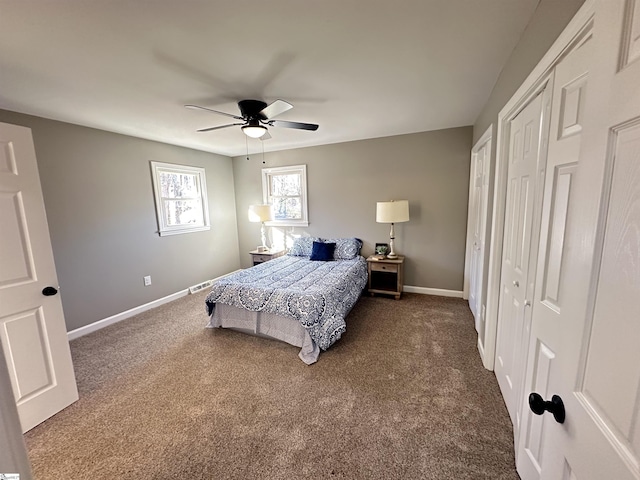 bedroom with dark colored carpet, a ceiling fan, and baseboards