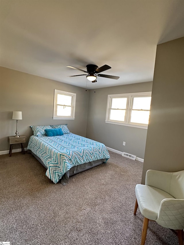 bedroom with a ceiling fan, baseboards, visible vents, and carpet flooring