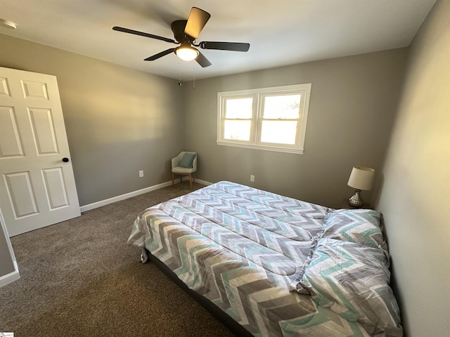 carpeted bedroom with ceiling fan and baseboards