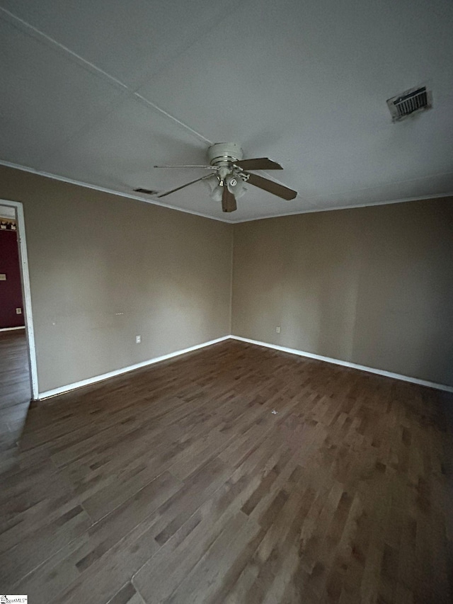 unfurnished room with ceiling fan and dark wood-type flooring