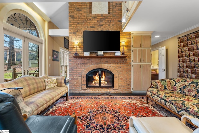 living room featuring french doors, crown molding, and a brick fireplace