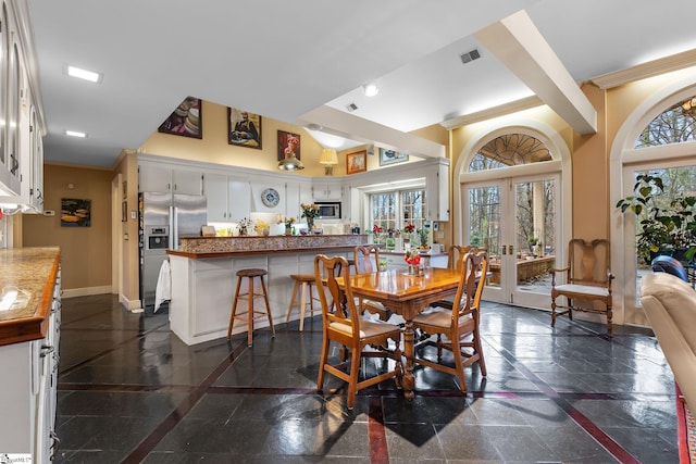 dining area with crown molding and french doors