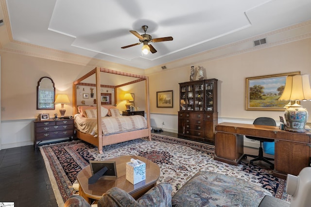 bedroom with a raised ceiling, ceiling fan, and crown molding