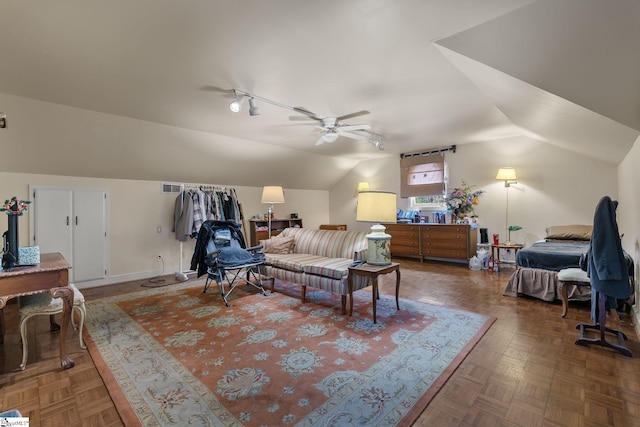 interior space featuring dark parquet flooring, ceiling fan, and lofted ceiling