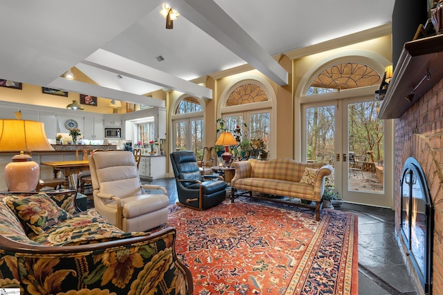 living room with ceiling fan, beam ceiling, and french doors