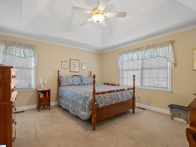 bedroom featuring ceiling fan, a raised ceiling, and light carpet