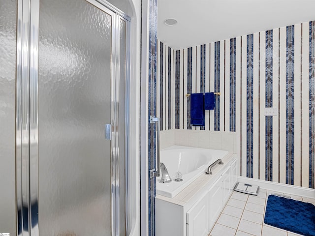 bathroom with tile patterned flooring and shower with separate bathtub