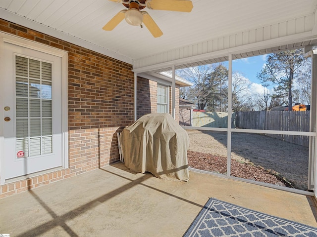 sunroom featuring ceiling fan