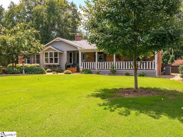 view of front facade featuring central AC unit and a front yard