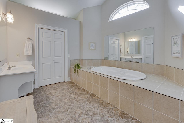 bathroom with vanity and lofted ceiling