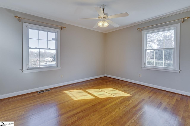 empty room with light hardwood / wood-style floors, ceiling fan, and crown molding