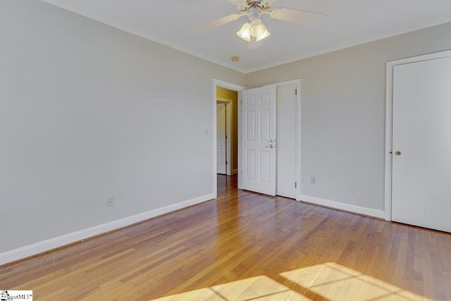 unfurnished bedroom with hardwood / wood-style flooring, ceiling fan, and ornamental molding