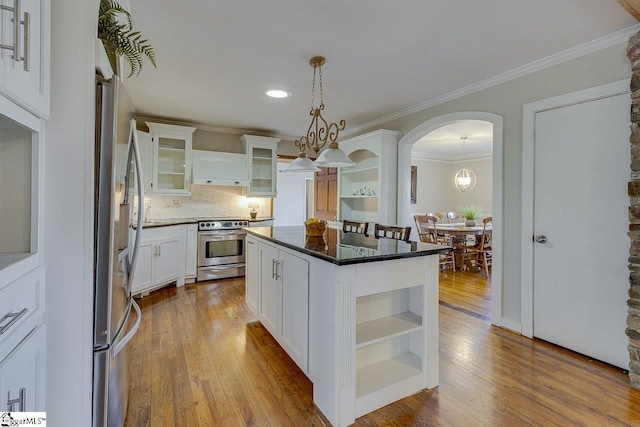 kitchen featuring a center island, white cabinets, hanging light fixtures, electric range, and light hardwood / wood-style floors