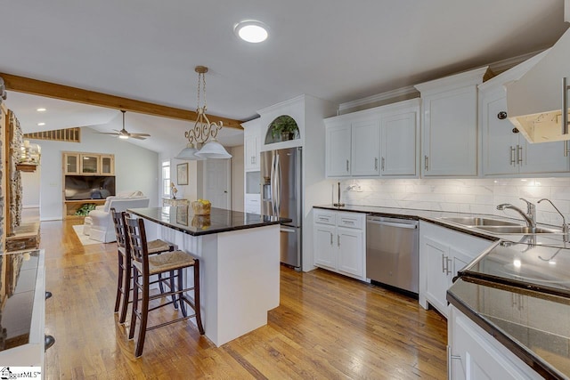 kitchen with ceiling fan, sink, tasteful backsplash, white cabinets, and appliances with stainless steel finishes