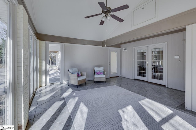 unfurnished sunroom featuring ceiling fan, french doors, and vaulted ceiling