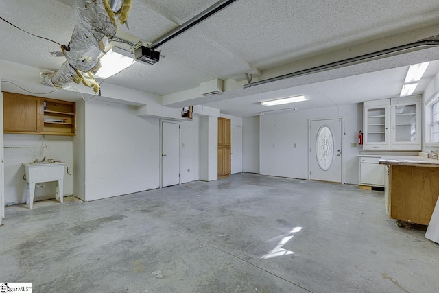 garage featuring sink and a garage door opener