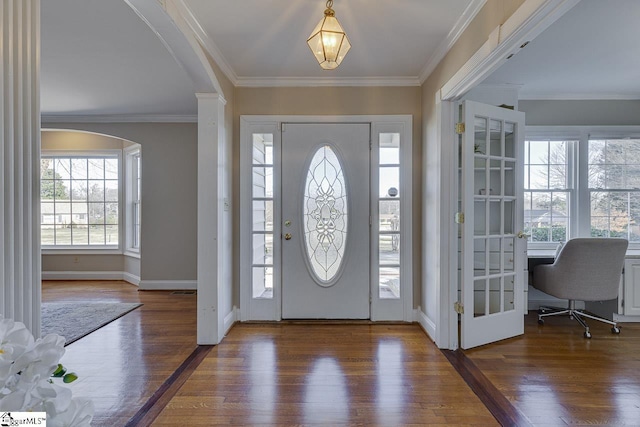 entrance foyer featuring crown molding and dark hardwood / wood-style floors