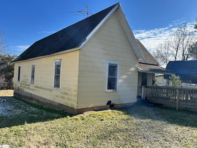 view of side of property with a yard