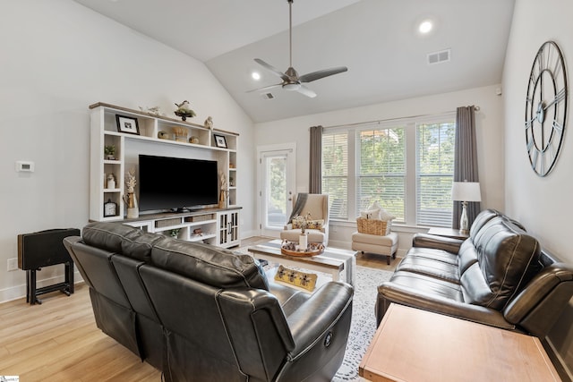 living room featuring light wood-type flooring, vaulted ceiling, and ceiling fan