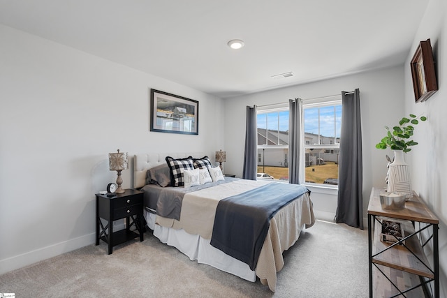 bedroom featuring light carpet