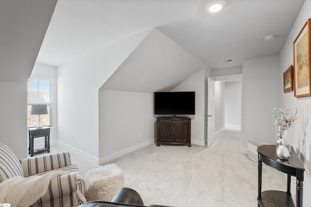 living room featuring light carpet and vaulted ceiling