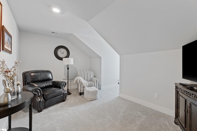 sitting room featuring light carpet and vaulted ceiling