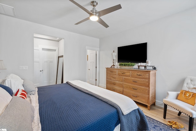 bedroom with ceiling fan and light hardwood / wood-style floors