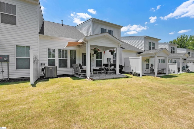 rear view of house with a yard, a patio, and central AC unit