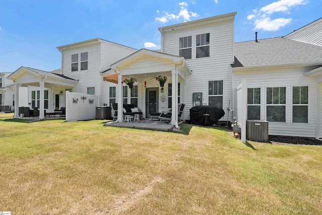 back of property featuring a lawn, central AC, and a patio