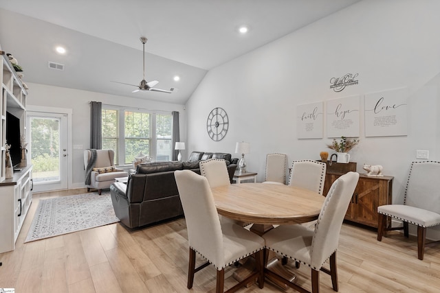 dining room featuring ceiling fan, light hardwood / wood-style floors, and vaulted ceiling