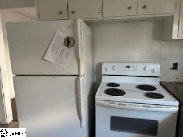 kitchen with white appliances and white cabinetry