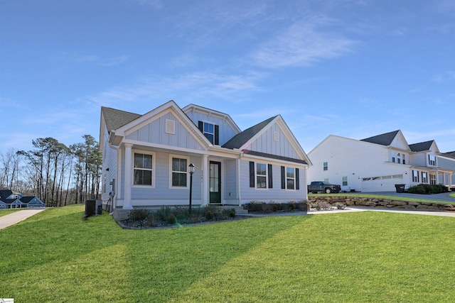 view of front of home featuring cooling unit and a front lawn